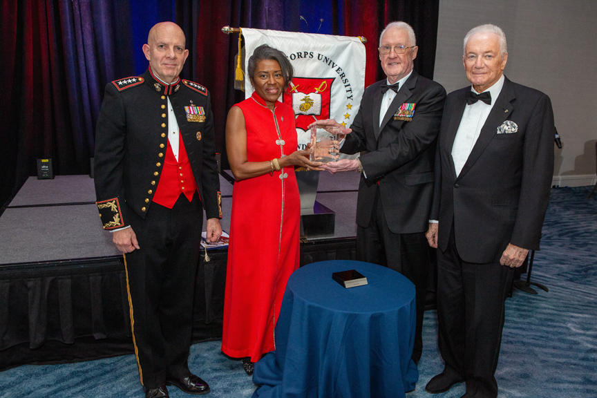 Center, Honoree Lt.Gov Winsome Earle-Sears receives the 2023 Semper Fidelis Award from LtGen Richard P. Mills, USMC (Ret). Left, the evening’s Military Guest of Honor the 38th Commandant of the Marine Corps, Gen David H. Berger, USMC, Right, MCU Foundation’s Vice Chairman Guy Wyser-Pratte