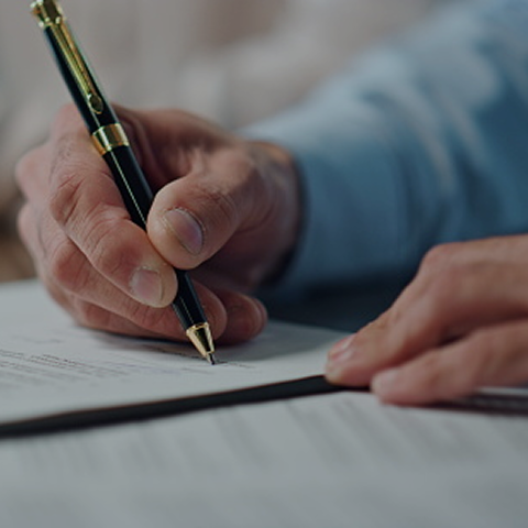 hand and pen on paper